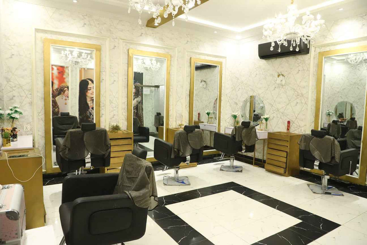 Modern spa and salon facial treatment room featuring massage beds and skincare machinery.